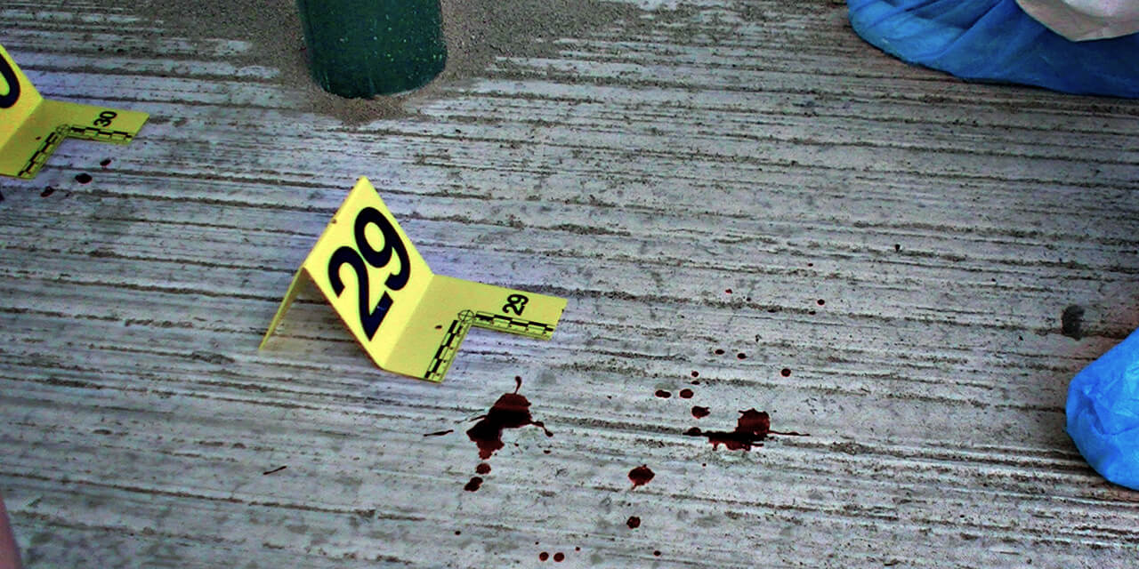 Blood splatters at a crime scene being examined